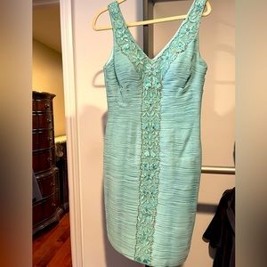 Sleeveless sue wing cocktail dress.